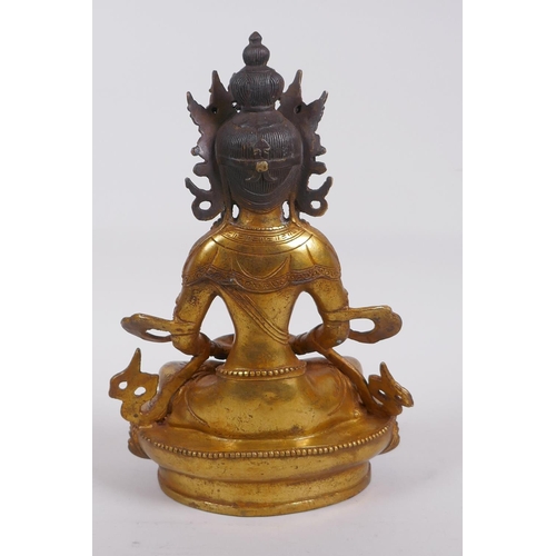 320 - A Sino Tibetan gilt bronze Buddha seated holding a stupa, impressed double vajra mark to base, 28cm ... 