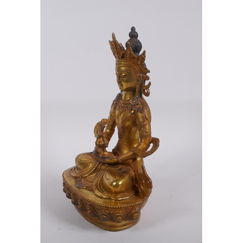 320 - A Sino Tibetan gilt bronze Buddha seated holding a stupa, impressed double vajra mark to base, 28cm ... 