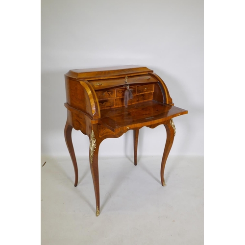 1001 - A rosewood marquetry inlaid bureau, with shaped top and cylinder front, the interior fitted with thr... 