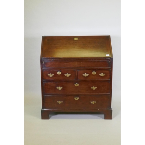 1002 - A Georgian mahogany bureau with two short over two long drawers, the full front fitted with pigeon h... 