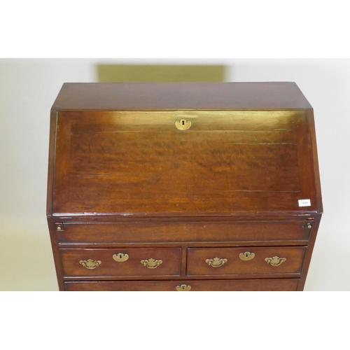 1002 - A Georgian mahogany bureau with two short over two long drawers, the full front fitted with pigeon h... 