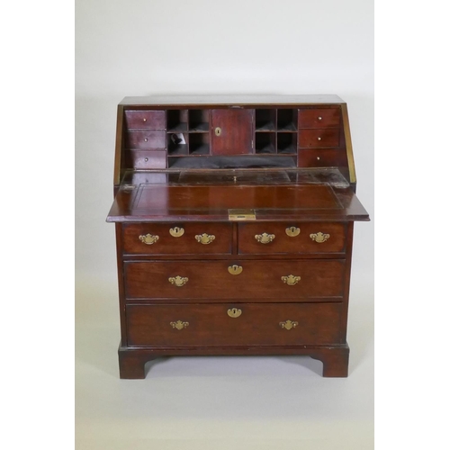 1002 - A Georgian mahogany bureau with two short over two long drawers, the full front fitted with pigeon h... 