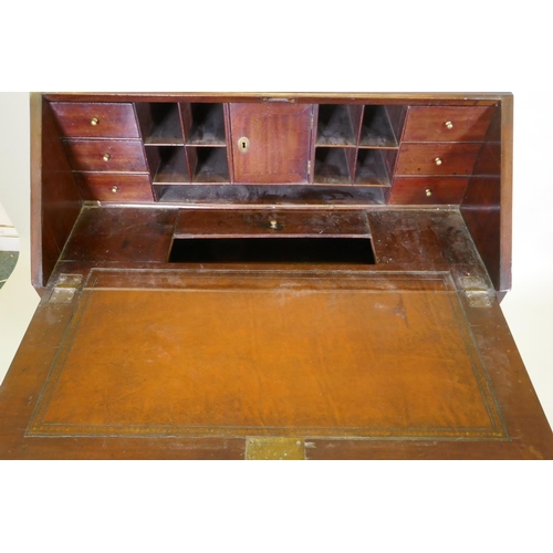 1002 - A Georgian mahogany bureau with two short over two long drawers, the full front fitted with pigeon h... 