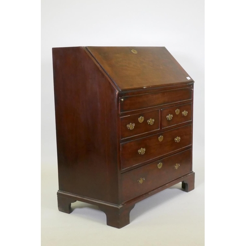 1002 - A Georgian mahogany bureau with two short over two long drawers, the full front fitted with pigeon h... 