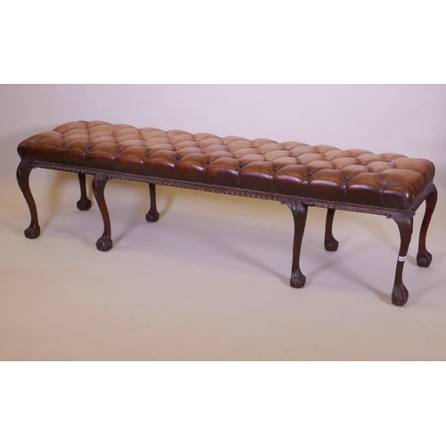 1003 - A mahogany bench raised on cabriole legs with claw and ball feet and a buttoned leather seat, 192 x ... 