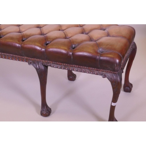 1003 - A mahogany bench raised on cabriole legs with claw and ball feet and a buttoned leather seat, 192 x ... 