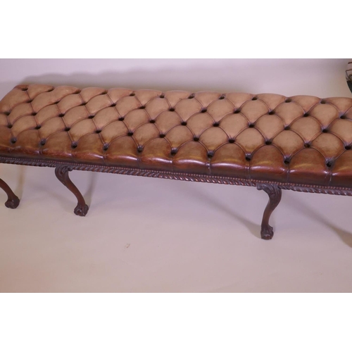 1003 - A mahogany bench raised on cabriole legs with claw and ball feet and a buttoned leather seat, 192 x ... 