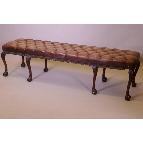 1003 - A mahogany bench raised on cabriole legs with claw and ball feet and a buttoned leather seat, 192 x ... 