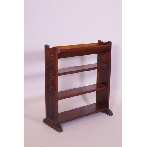 1006 - An Arts & Crafts oak open bookshelf with trough top, the sides carved with a serpent coiled arou... 