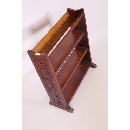 1006 - An Arts & Crafts oak open bookshelf with trough top, the sides carved with a serpent coiled arou... 