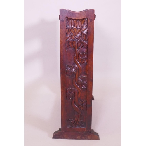 1006 - An Arts & Crafts oak open bookshelf with trough top, the sides carved with a serpent coiled arou... 