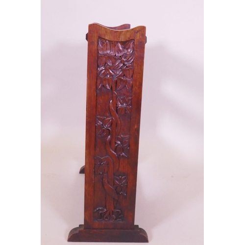 1006 - An Arts & Crafts oak open bookshelf with trough top, the sides carved with a serpent coiled arou... 