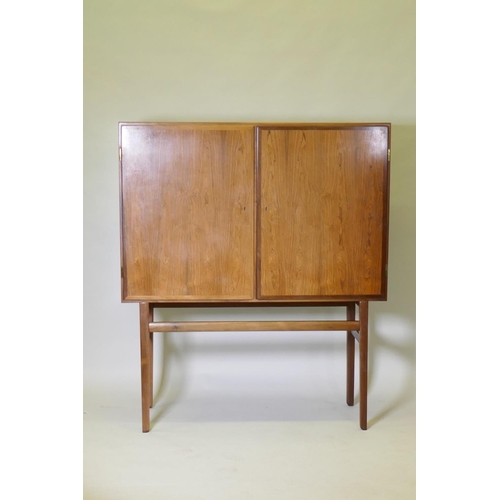 1017 - A mid century Danish side cabinet, designed by Ole Wanscher for Poul Jeppesen, labelled verso, raise... 