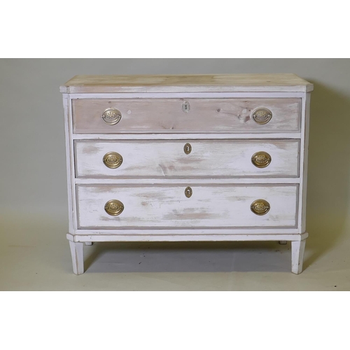 1019 - An antique painted and distressed pine commode, with three long drawers, canted corners and raised o... 