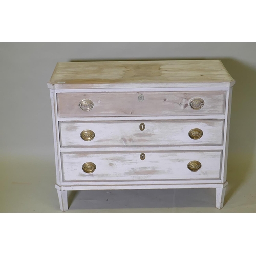 1019 - An antique painted and distressed pine commode, with three long drawers, canted corners and raised o... 