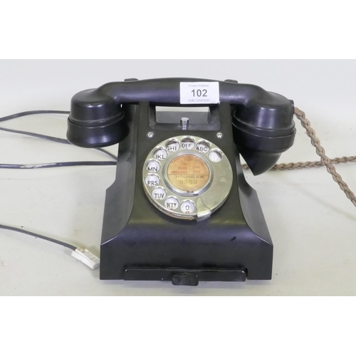 102 - A vintage black bakelite telephone with pull out slide