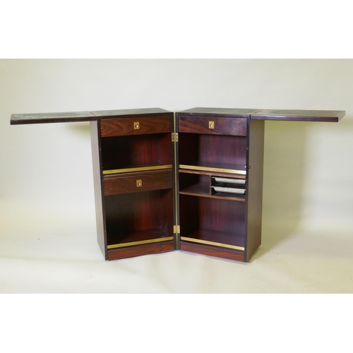 1021 - A Danish Dyrlund bar unit, with two fold out sections fitted with drawers and metal trays, and fol o... 