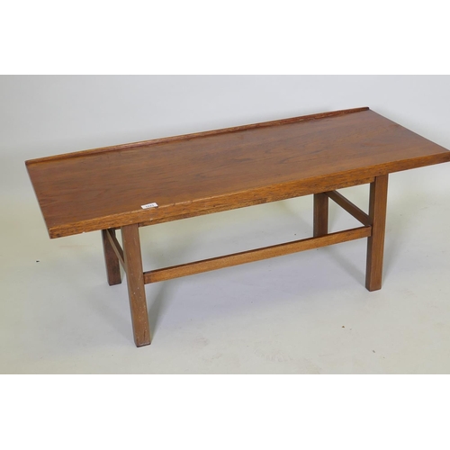 1023 - A mid century coffee table, with gallery top, raised on square supports united by stretchers, 114 x ... 