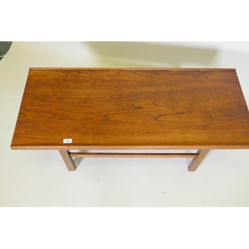 1023 - A mid century coffee table, with gallery top, raised on square supports united by stretchers, 114 x ... 