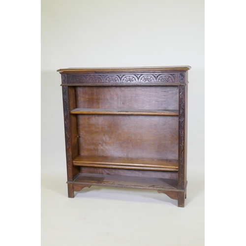 1024 - A C19th oak open bookcase with carved frieze, 107 x 25cm, 113cm high