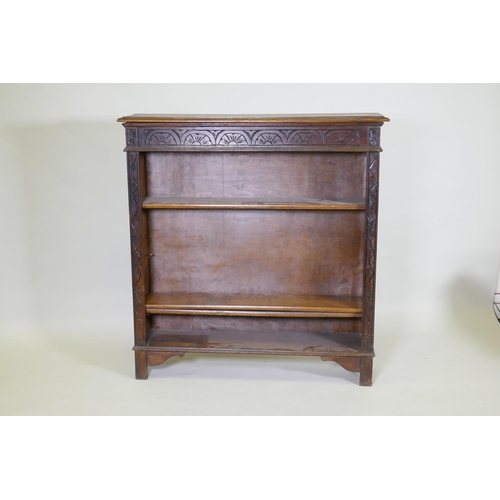 1024 - A C19th oak open bookcase with carved frieze, 107 x 25cm, 113cm high