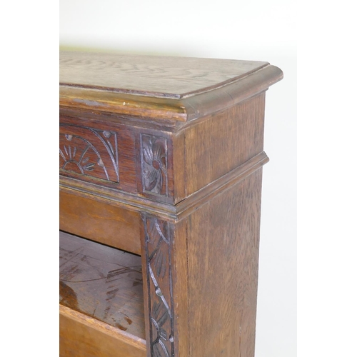 1024 - A C19th oak open bookcase with carved frieze, 107 x 25cm, 113cm high