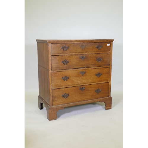 1027 - A Georgian oak garret chest in two sections, original brass fret handles and scratch moulded drawers... 