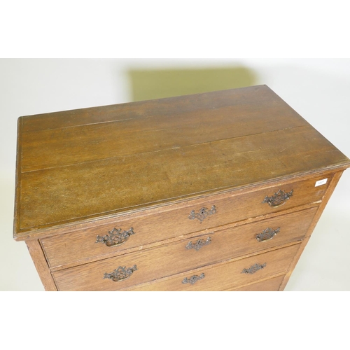 1027 - A Georgian oak garret chest in two sections, original brass fret handles and scratch moulded drawers... 