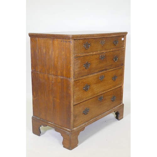 1027 - A Georgian oak garret chest in two sections, original brass fret handles and scratch moulded drawers... 