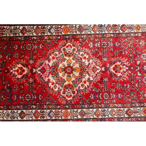 1033 - A rich red ground full heavy pile Iranian runner, AF, 104 x 365cm