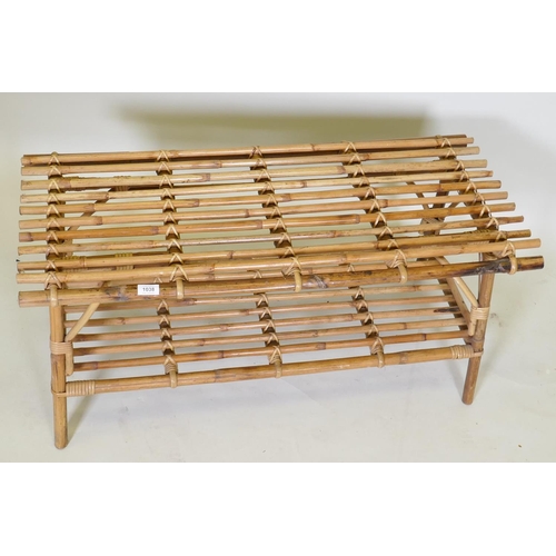 1038 - A two tier bamboo occasional table, 102 x 48cm, 45cm high