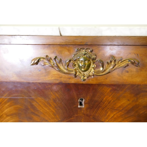 1041 - A C19th continental figured mahogany secretaire a abattant with ormolu mounts and marble top over si... 