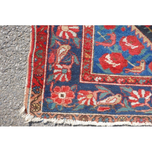 1043 - An Iranian Hamadan multicolour ground wool rug decorated with birds and flowers, 138 x 206cm