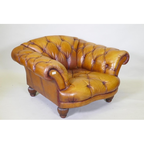 1044 - A Tetrad button leather easy chair and footstool