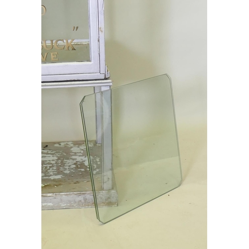 1048 - A mid century glass display cabinet on stand with painted decoration, 57 x 58cm, 218cm high