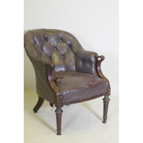 1052 - A William IV button back leather desk chair, repairs