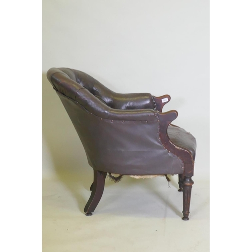 1052 - A William IV button back leather desk chair, repairs