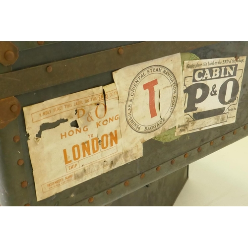 1055 - A vintage metal strapped travel trunk adorned with various cabin labels, together with a large metal... 