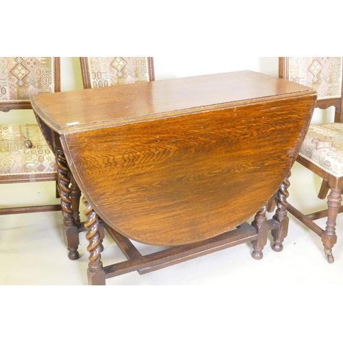 1057 - A c19th oak gateleg table with barley twist supports, and four oak dining chairs with carved and flu... 