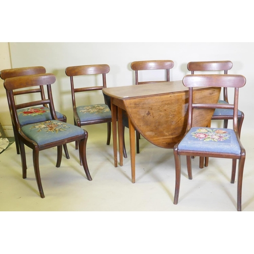 1058 - A George III mahogany drop leaf table and a set of six mahogany dining chairs with bar backs and dro... 