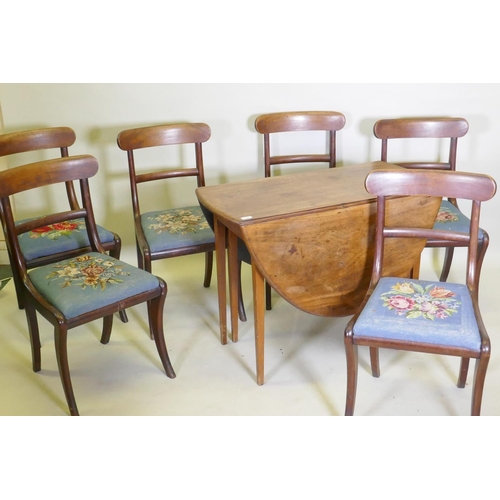 1058 - A George III mahogany drop leaf table and a set of six mahogany dining chairs with bar backs and dro... 