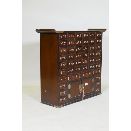 1071 - A Japanese hardwood and brass mounted apothecary cabinet, 77x 24cm