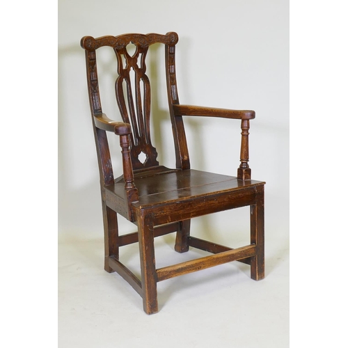 1072 - A C19th elm open armchair with later carving