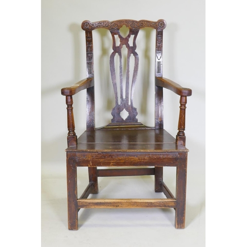 1072 - A C19th elm open armchair with later carving