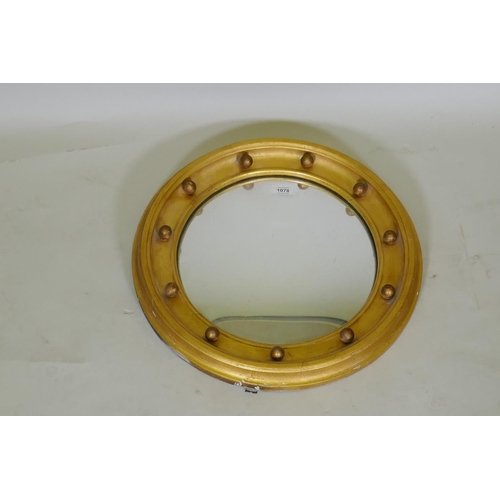 1078 - A C19th Regency style giltwood circular wall mirror with convex glass, 50cm diameter