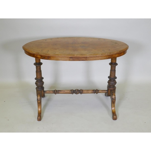 1080 - A C19th inlaid walnut stretcher table, with an oval top and turned supports, 91 x 51cm, 64cm high