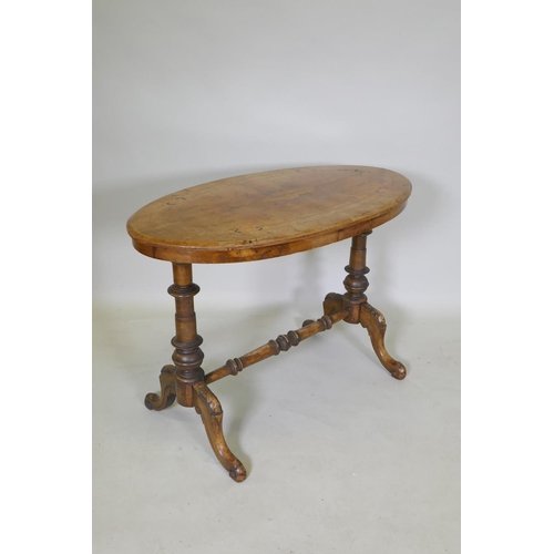 1080 - A C19th inlaid walnut stretcher table, with an oval top and turned supports, 91 x 51cm, 64cm high