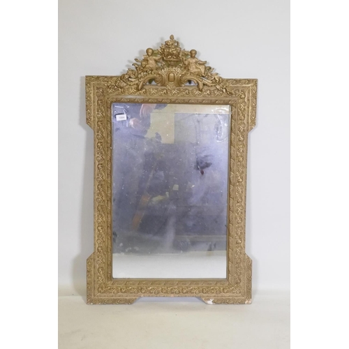 1084 - A C19th French giltwood and composition wall mirror with pierced crest decoration, 68 x 108cm