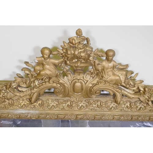 1084 - A C19th French giltwood and composition wall mirror with pierced crest decoration, 68 x 108cm