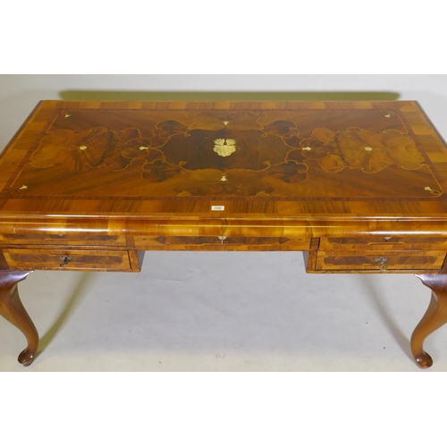 1086 - A continental walnut and marquetry inlaid bureau plat, with five drawers, raised on cabriole support... 